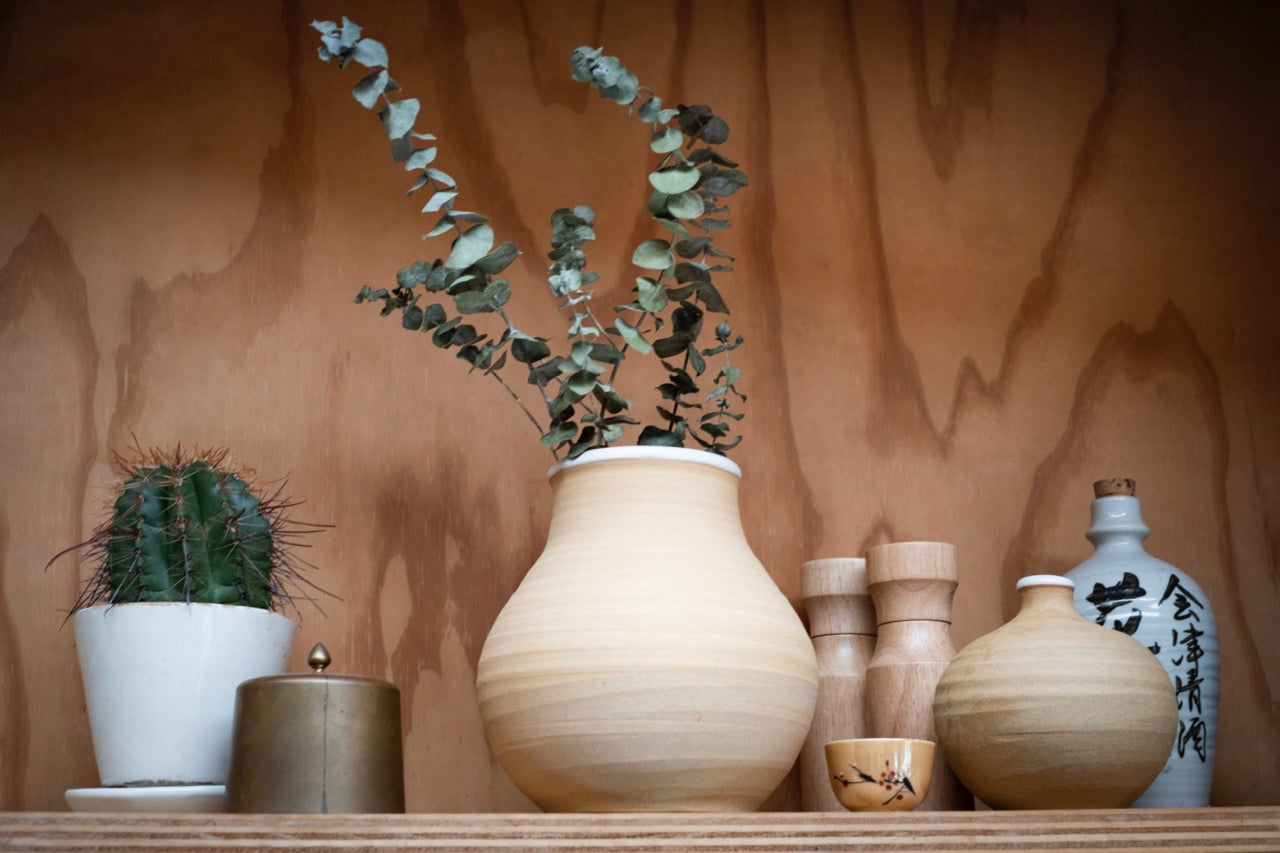 vases on a wooden shelf
